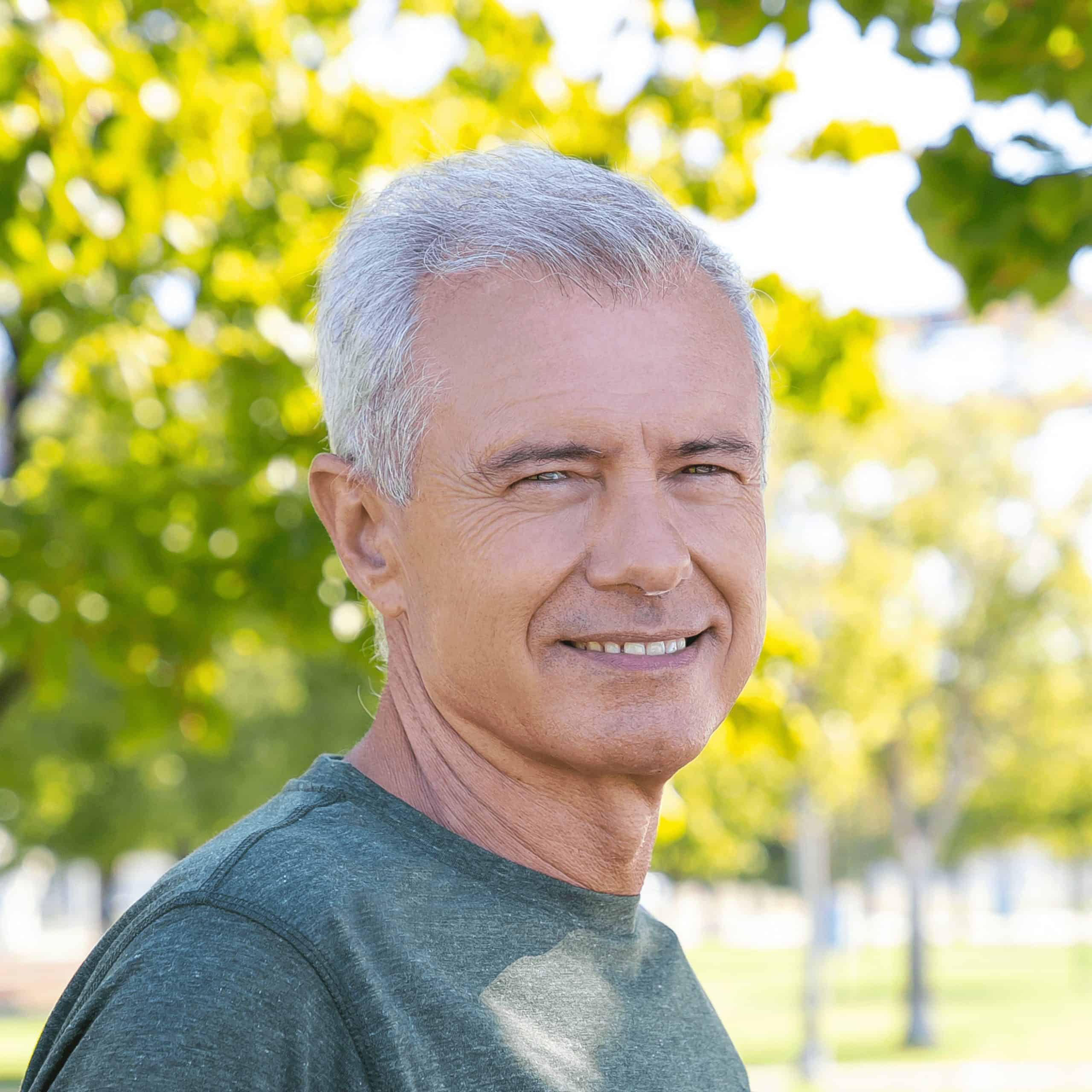 An older man smiles outdoors, showing confidence and trust in Wooley Water Sewer Trenchless solutions in Carroll, OH.